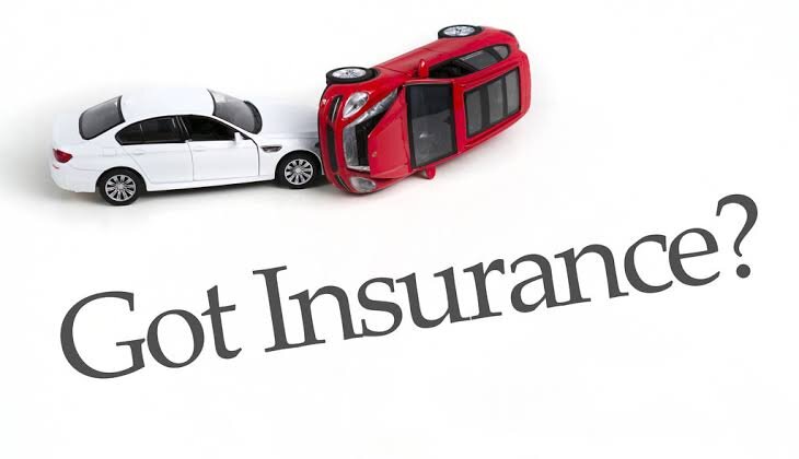 A red toy car flipped onto its side against a white toy car, above the words Got Insurance.
