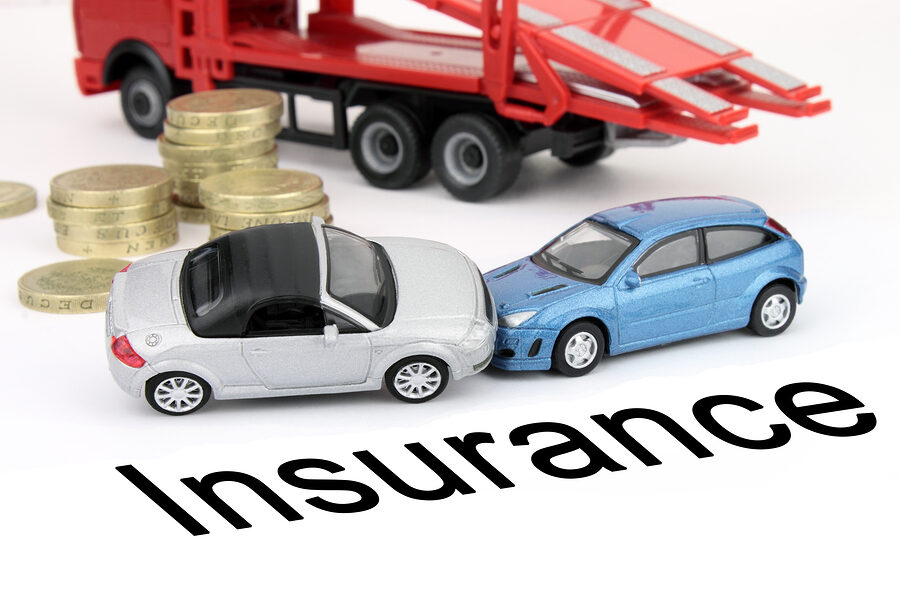 Two toy cars in a rear end collision beside stacks of coins and a toy tow truck, above the word Insurance.
